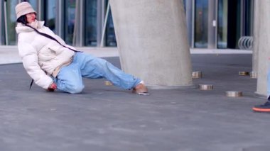 This short video features a diverse group engaging in urban activities, from a man climbing a pole to moments shared on a bustling sidewalk