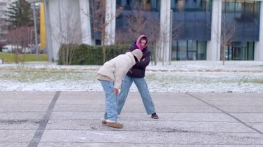 Experience winters beauty in videos of interactions two women on a snowy street, a couple chatting, and a woman with a boy