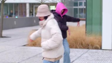 The video features street dance scenes a girl in black moves energetically, a couple synchronizes, and others add to the vibrant atmosphere