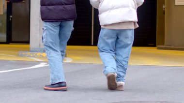 This heartwarming video features moments of connection a man helps another with a cane, a couple together, a man holds a child, and couples walking