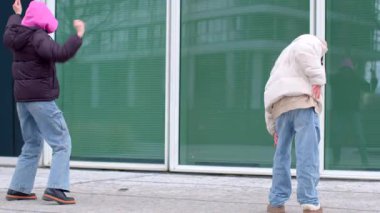 This lively video showcases a couple dancing in an urban setting, with others joining in, capturing the joy of connection in a bustling city