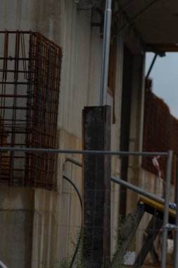 A close-up view of a construction site showcasing a metal framework and scaffolding structures, highlighting the progress of building development.