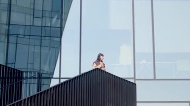 This video showcases moments of contemplation from a womans perspective standing on a balcony, exploring the city, and capturing beauty