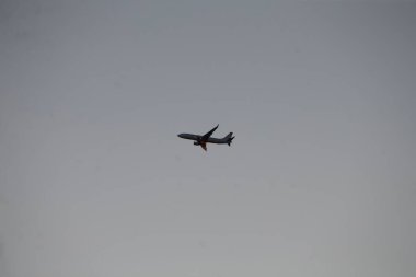 An airplane soaring through the sky, captured in mid-flight, showcasing aviation and travel themes.
