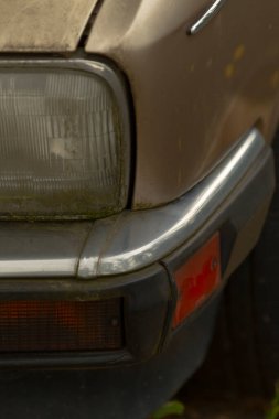 An up-close view of a rusty vintage car bumper showcasing aging paint and wear.