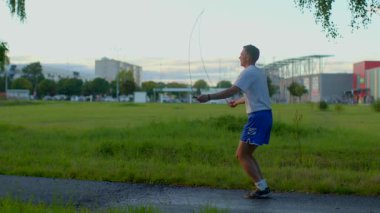 A man strolls through a serene park on his phone before switching to a brisk run. The video highlights the mix of relaxation and fitness