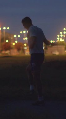 A nighttime scene shows a lone figure, shifting to a man kicking a soccer ball, then blurring to another man in thought, exploring movement and introspection