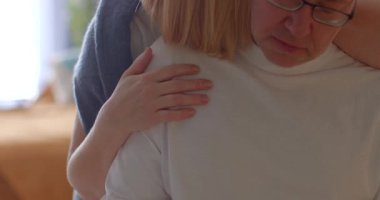 A tender scene showcasing emotional support and connection between two individuals in a cozy indoor setting.