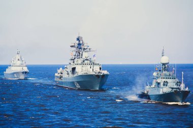 A line of modern russian military naval battleships warships in the row, northern fleet and baltic sea fleet in the open se clipart