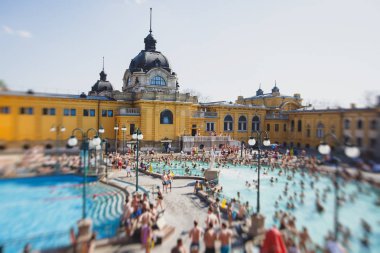 Budapest Spa Szechenyi Thermal Bath spa swimming pool with blue sky in summer day with a crowd of peopl clipart