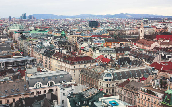 Beautiful super-wide angle aerial view of Vienna, Austria, with old town Historic Center and scenery beyond the city, shot from observation deck of Saint Stephens's Cathedra