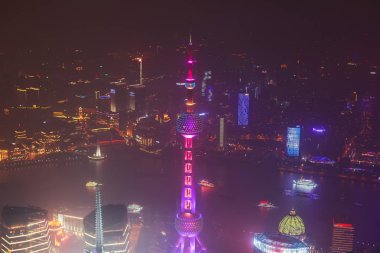 Beautiful super wide-angle night aerial view of Shanghai, China with Pudong district, TV tower, the Bund and scenery beyond the city, seen from the observation deck of Shanghai World Financial Cente clipart