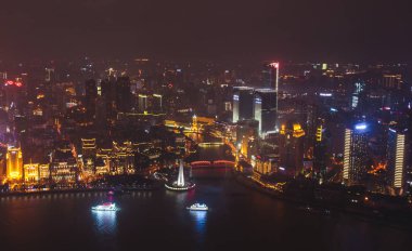 Beautiful super wide-angle night aerial view of Shanghai, China with Waitan, The Bund and scenery beyond the city, seen from the observation deck of Oriental Pearl TV Towe clipart