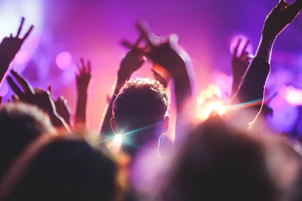 View of rock concert show in big concert hall, with crowd and stage lights, a crowded concert hall with scene lights, rock show performance, with people silhouette