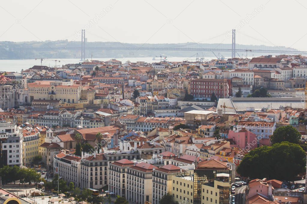 Beautiful super wide-angle aerial view of Lisbon, Portugal with harbor and skyline scenery beyond the city, shot from