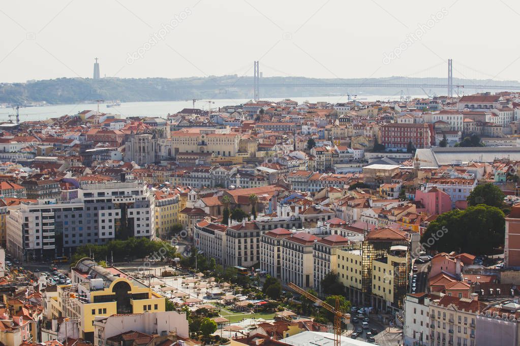 Beautiful super wide-angle aerial view of Lisbon, Portugal with harbor and skyline scenery beyond the city, shot from