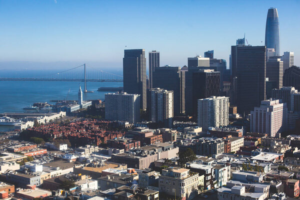 Beautiful super wide-angle aerial view of San Francisco, California, with Bay Bridge, Downtown, Ferry Market, and skyline scenery beyond the city, seen from the observation deck of Coit Towe