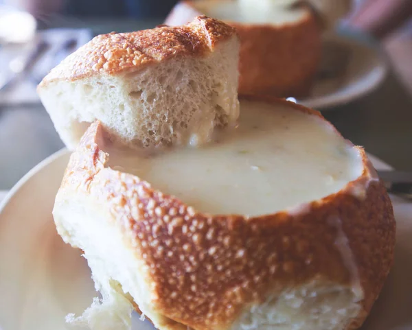 Close up view of New England Clam chowder in bread, traditional american soup with clam and broth, Californi