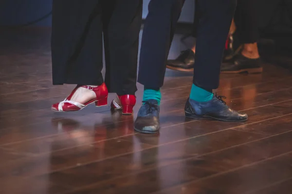 Dancing shoes of young couple dance retro jazz swing dances on a ballroom club wooden floor, close up view of shoes, female and male, dance lessons