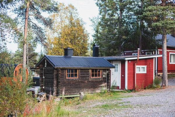 View of Classical swedish Camping site with traditional wooden red cabin cottage houses, Lapland, Northern Swede