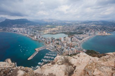 View of Calpe Calp town with Penon de Ifach mountain during the hiking to Penyal d'Ifac Natural Park, Marina Alta, province of Alicante, Valencian Community, Spain clipart