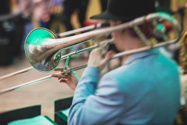 Concert view of a trombone player trombonist with musical jazz band group performin
