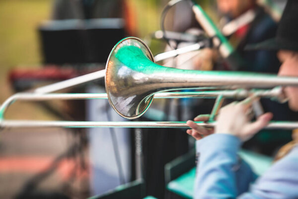 Concert view of a trombone player trombonist with musical jazz band group performin