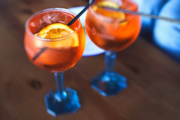 Row line of red colored negroni and spritz aperitif alcohol cocktails on a party of alcohol setting on catering banquet table, vodka, and others on decorated catering table event 
