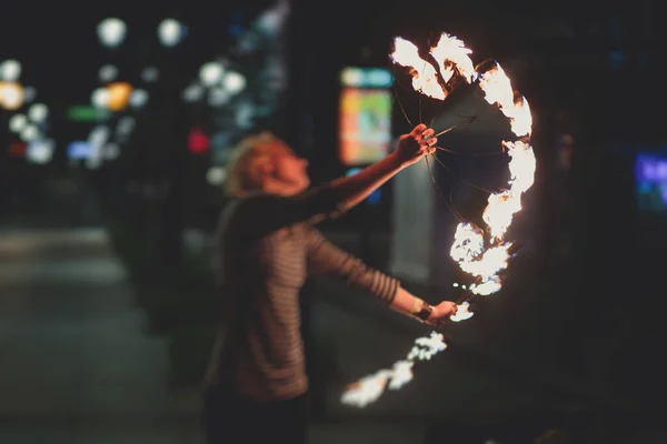 Group of fire artists fakir perform amazing show at night with flamethrowers, fire dancers, chain of fire, extreme flame breathing