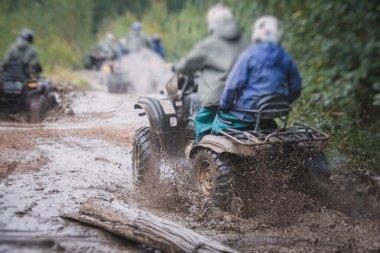 ATV aracını off road yolunda süren bir grup sürücü, ATV aracını sürme süreci, tüm arazi motorlu aracı, off-road yarışması sırasında, mu mu 'yu geçerken,