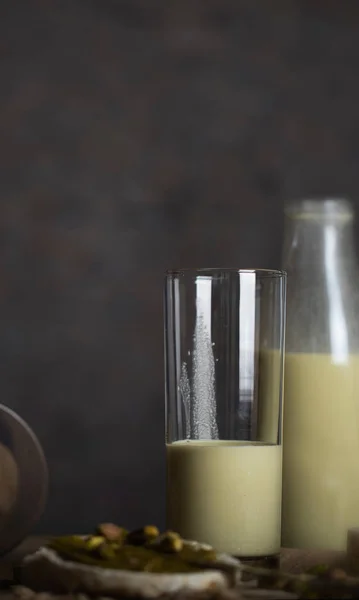 Homemade pistachio nut milk in a glass bottle. — Stock Photo, Image