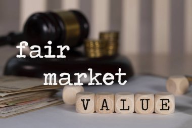 Words FAIR MARKET VALUE composed of wooden dices.  clipart