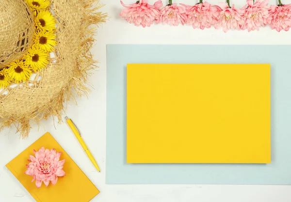 Mockup yellow frame with summer straw hat and notes