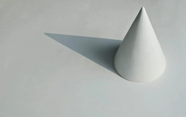 the geometric shape of the cone on white background, copy space