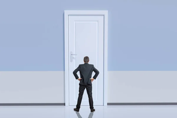 Businessman is standing behind big door. Opportunity and challenge concept.