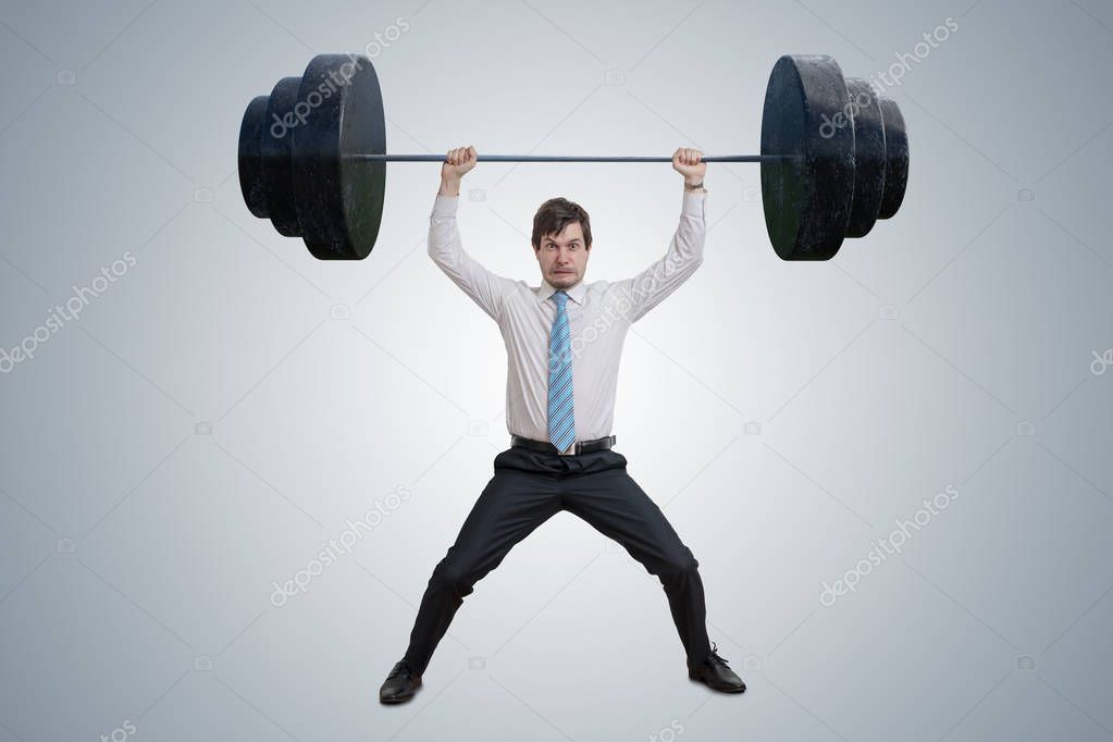 Young businessman in shirt is lifting heavy weights.