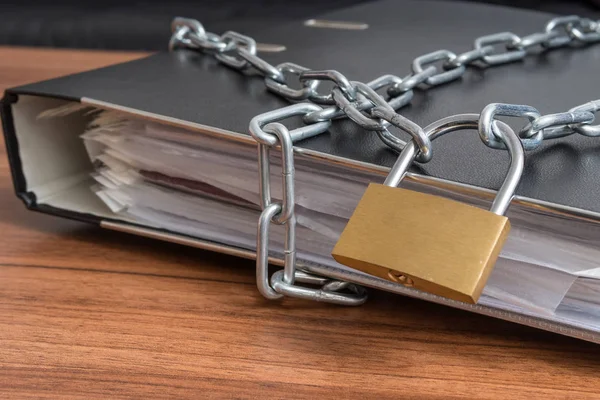 Confidential files and documents in binder locked. Privacy and security concept.