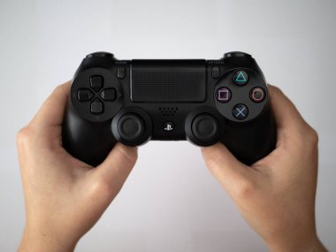 Uk, Ekim 2019: Sony Dualshock Playstation 4 oyun konsolu uzaktan kumandası beyaz arkaplan üzerinde tutuluyor