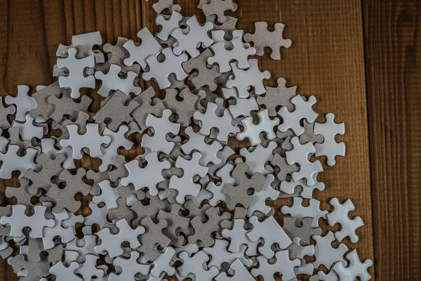 White jigsaw puzzle that has been placed on a desk