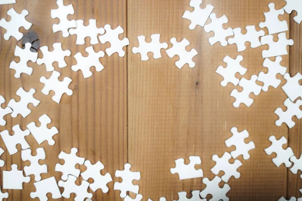 White jigsaw puzzle that has been placed on a desk
