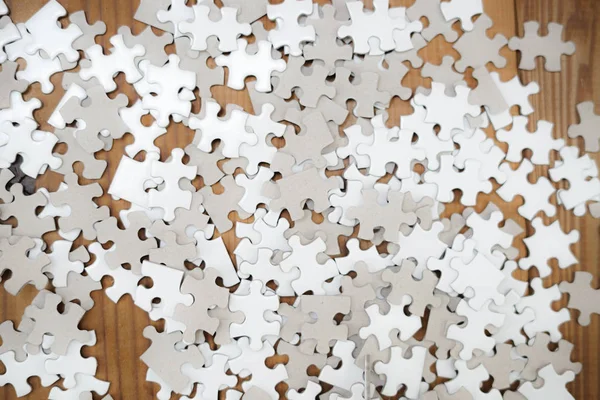 White jigsaw puzzle that has been placed on a desk