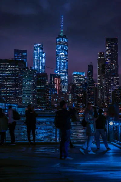 Manhattan and Brooklyn bridge night view and the people