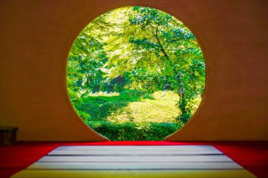 Round window and the fresh green of Meigetsuin clipart