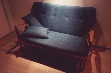 Işıkla aydınlatılmış şık bir kanepe.