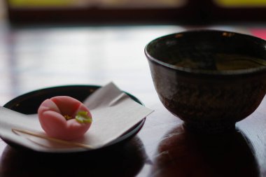 Green tea and sweets that were placed in the Japanese-style table clipart