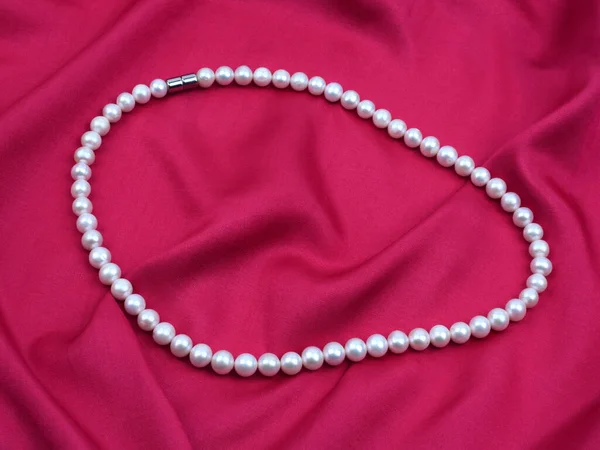 Biały Perłowy Naszyjnik Czerwonym Jedwabnym Materiale Satynowym — Zdjęcie stockowe