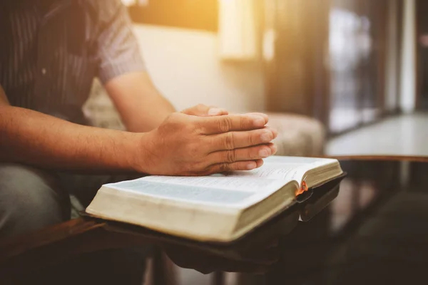 Közelről Egy Férfi Kezét Imádkozik Szent Biblián Miközben Otthon Kanapén — Stock Fotó