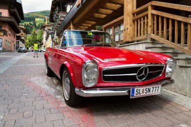 SAALBACH-HINTERGLEMM, AUSTRIA - JUNE 21 2018: Vintage car Mercedes-Benz 230 SL oldsmobile veteran preparing for Saalbach Classic rally on June 21, 2018 in Saalbach-Hinterglemm, Austria. clipart