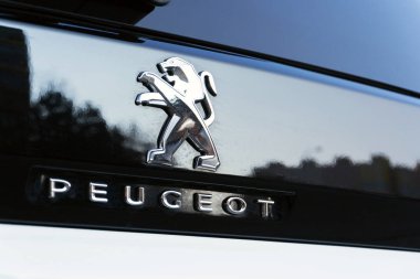 PRAGUE, CZECH REPUBLIC - MARCH 29 2018: Peugeot company logo on silver car on March 29, 2018 in Prague, Czech Republic. clipart