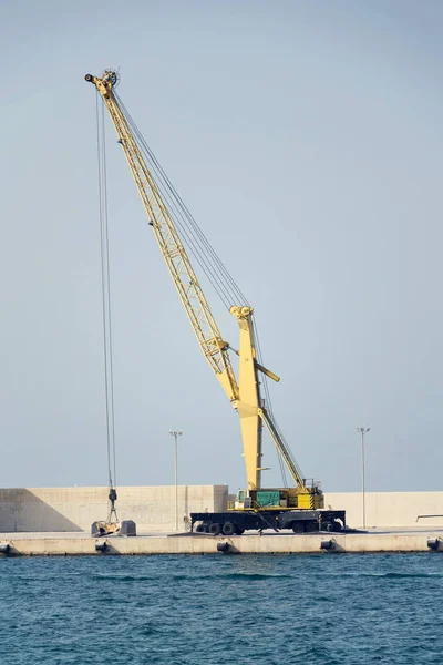 stock image Empty shipping harbor with yellow crane, freight digitalization, transportation efficiency concept, sunny day copy space